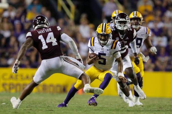 Sep 17, 2022; Baton Rouge, Louisiana, USA; LSU Tigers quarterback Jayden Daniels (5) scrambles against Mississippi State Bulldogs linebacker Nathaniel Watson (14) during the second half at Tiger Stadium. Mandatory Credit: Stephen Lew-USA TODAY Sports